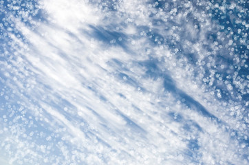 Falling snowflakes on  blue background