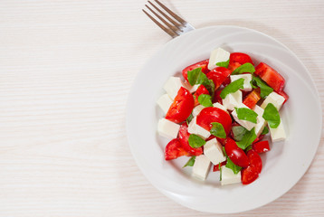 salad with cheese, tomatoes and basil
