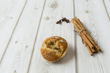 Cupcake with cinnamon on wood