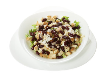 Delicious salad of beans, cabbage, onion, egg, cucumber, served in a white bowl. Isolated on white.