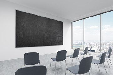 A classroom or presentation room in a modern university of fancy office. Black chairs, panoramic windows with New York view and a black chalkboard on the wall. 3D rendering.