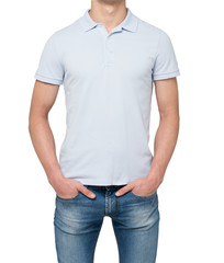 Man wearing light blue polo shirt and denims. Hands are in the pockets. isolated on white background.