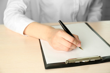 Businesswoman writing on document