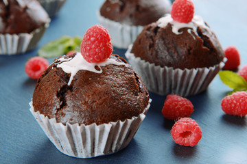 Delicious chocolate cupcakes with berries on table close up