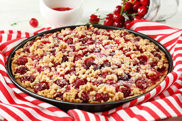 Tasty homemade pie with cherries on table close up