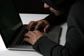 Hacker with computer and laptop on colorful dark background