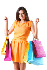 Beautiful young woman with shopping bags isolated on white