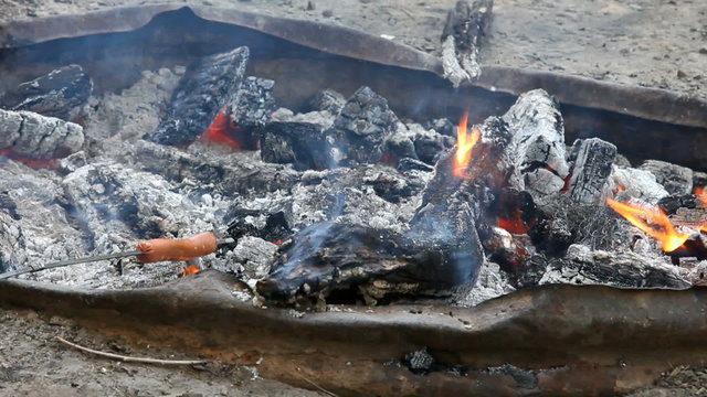 roasting a hotdog over fire campfire P HD 1965