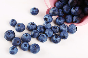 Tasty ripe blueberries in bucket on table close up