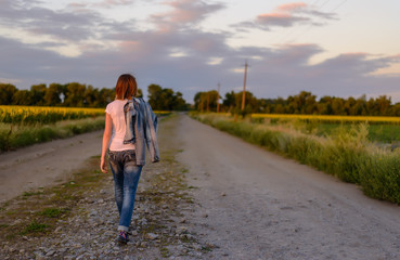 Woman walking down a country road