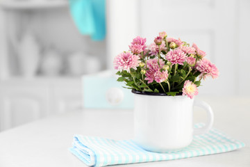 Fototapeta na wymiar Beautiful flowers in vase on table, on light background