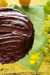composition of sweet chocolate dessert and fruits on yellow wooden background