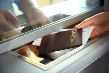 Obraz premium Woman buying tickets with passport at box office