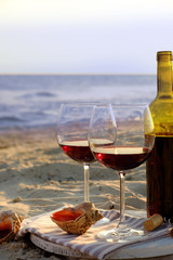Wine bottle and glasses on the seashore