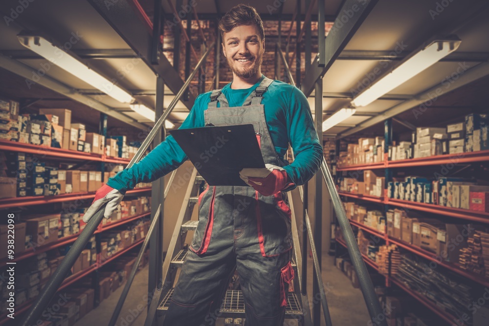 Wall mural worker on a automotive spare parts warehouse