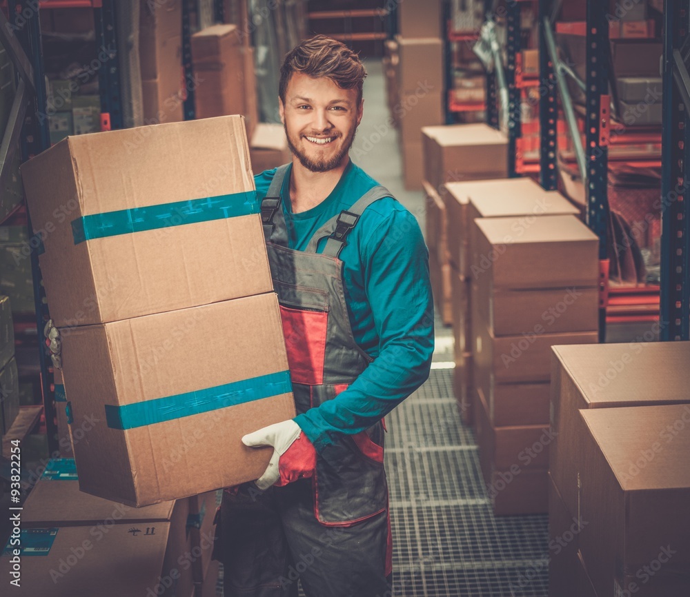 Wall mural porter carrying boxes in a warehouse