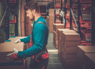 Porter carrying boxes in a warehouse