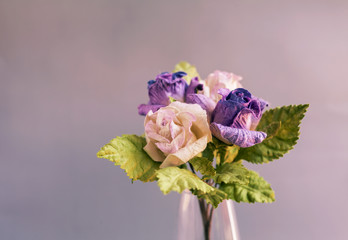 Closeup purple paper roses vintage tone style 