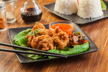 Chicken pieces in batter with sweet and sour sauce