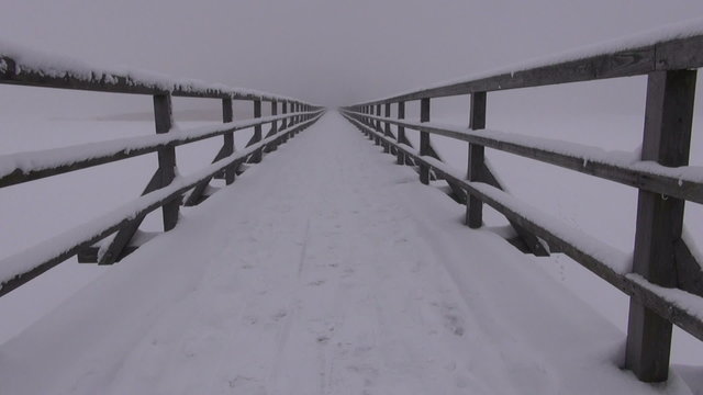 Winter day foggy snowy landscape cameraman walking while filming