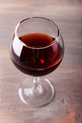 Glass of red wine on wooden table