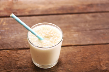 Fresh yogurt with tubule on wooden background