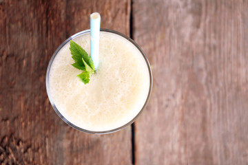 Fresh yogurt with mint on wooden background