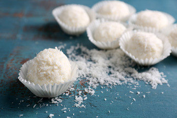 Coco sweets on color wooden background