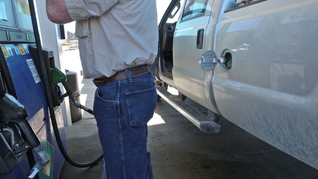 Man filling gas into pickup truck HD 3525