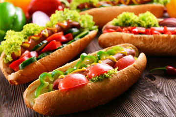 Hot dogs on wooden background closeup