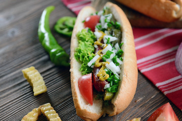 Hot dog on napkin on wooden background