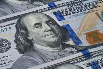 Banknotes in denominations of one hundred dollars photographed close up © viktorius_73