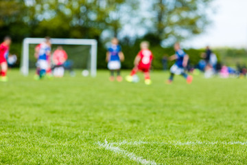Obraz na płótnie Canvas Blur of children playing soccer