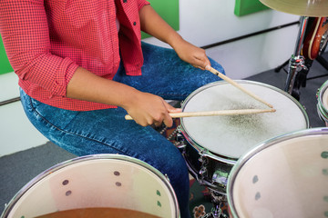 Midsection Of Female Drummer Performing
