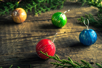Colourful Christmas balls on wooden background. Vintage toned photo