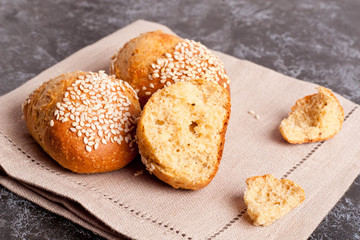 Fresh homemade bread rolls with sesam seed on table