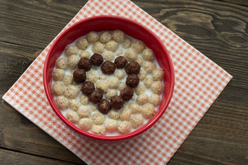 Heart of chocolate cereal balls with milk