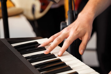 Obraz premium Hand Playing Piano In Recording Studio