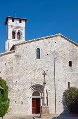Fototapeta na wymiar The facade of a medieval church Saint-Pierre-aux-liens of Ruoms.
