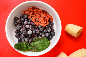 Ingredients for fruit smoothies with banana, blueberries, goji berries and mint