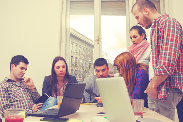 Young group of people discussing business plans.