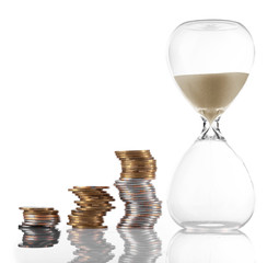 Hourglass with coins isolated on white