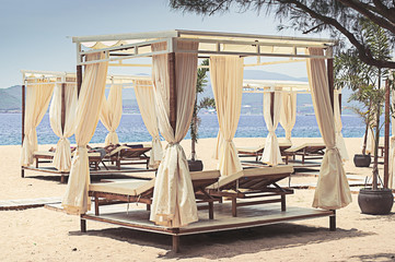 Comfotable chaise with canopy on vip beach