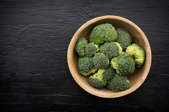 Overhead view with broccoli on black slab background