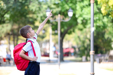 Little boy with large school bag, outdoor