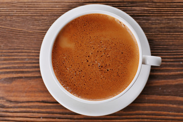 Cup of coffee on wooden background
