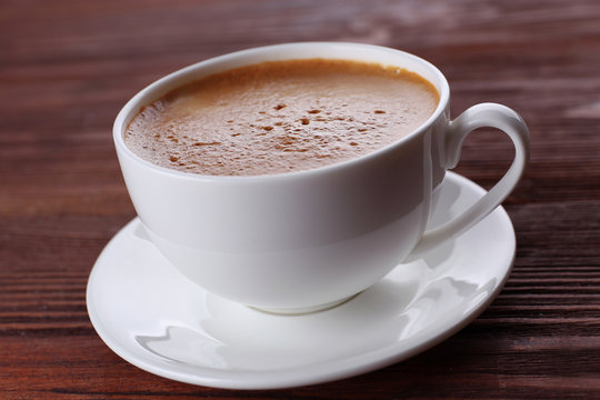 Cup of coffee on wooden background