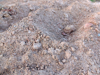 Wheel track in laterite soil excavation site, construction textu