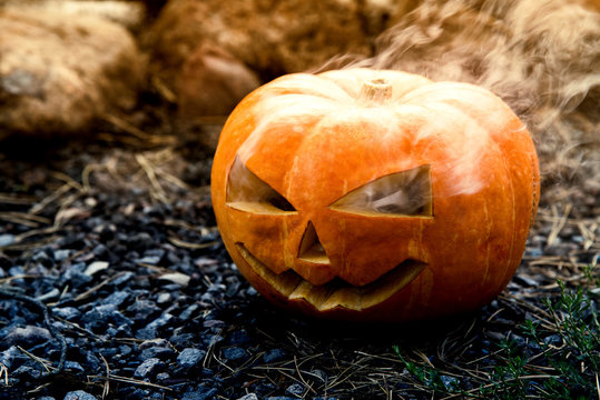 Jack o Lantern. The smoking Halloween spooky pumpkin
