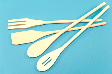 Wooden cutlery set isolated on blue background